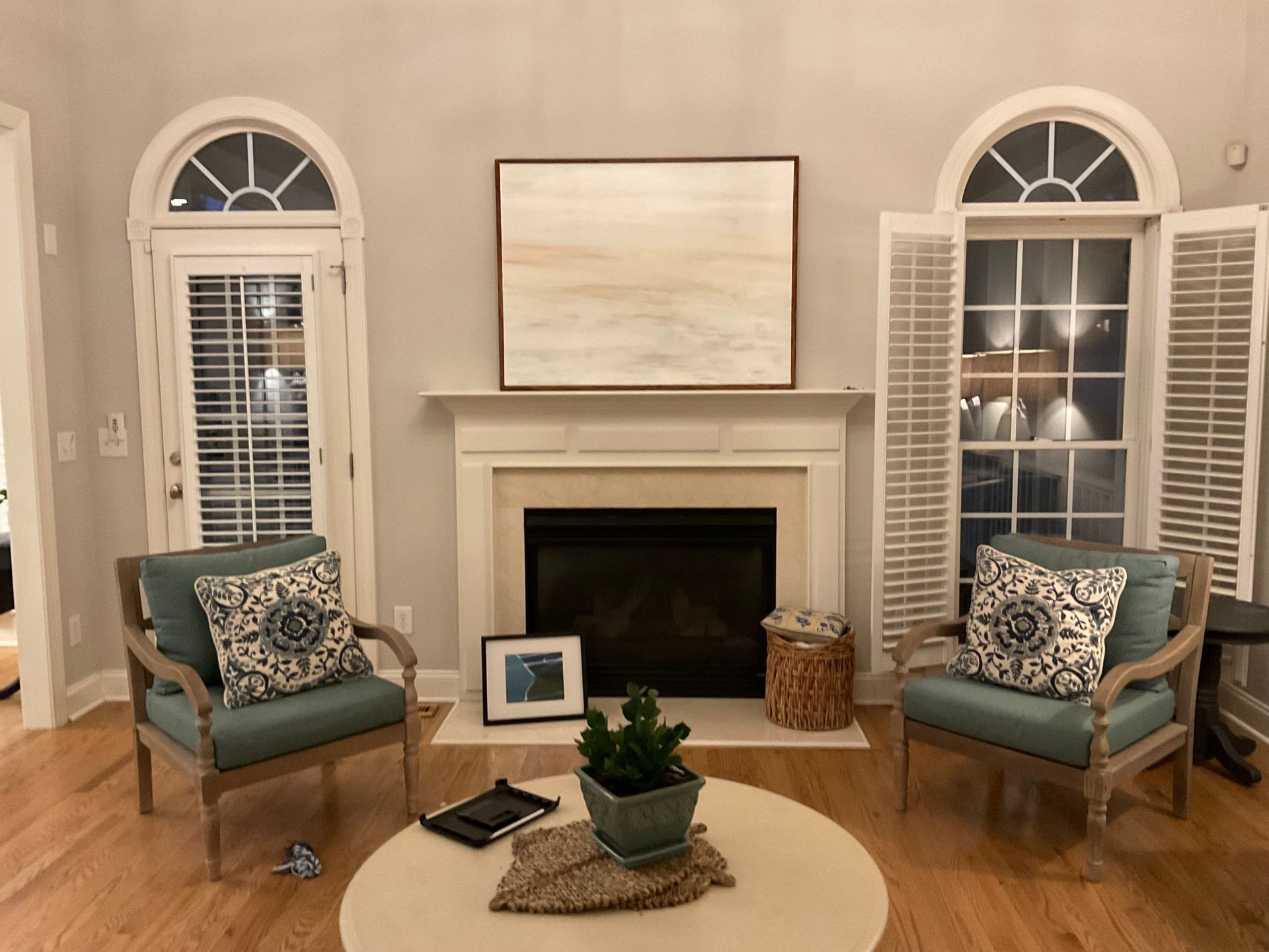 A living room with two chairs and a fireplace