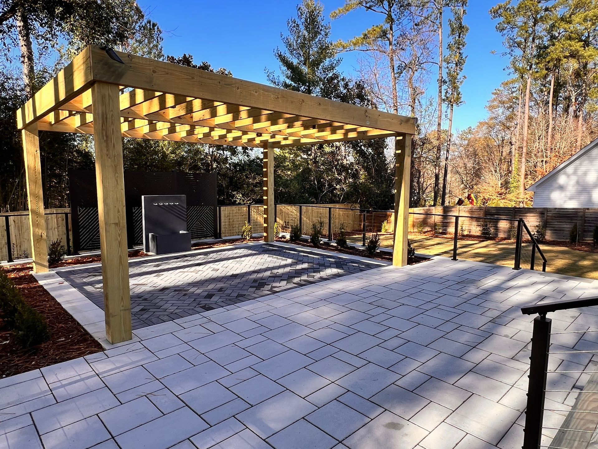 A wooden pergola is sitting on top of a patio