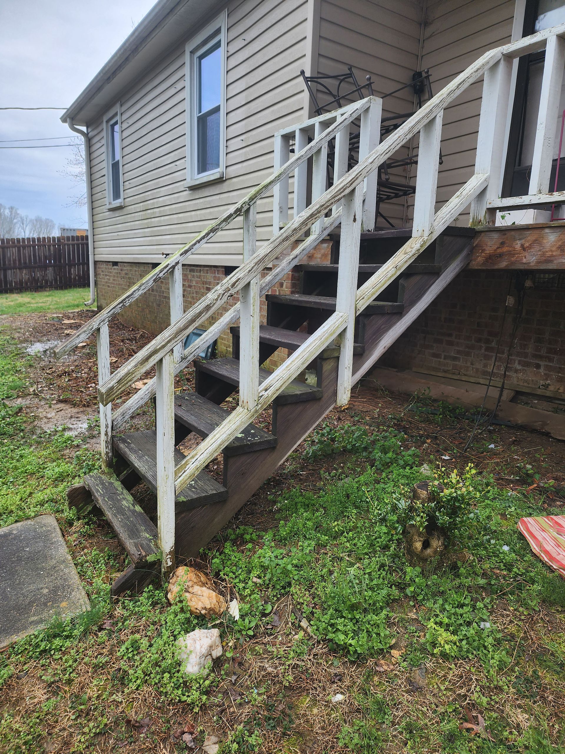 A house with stairs leading up to the front door.