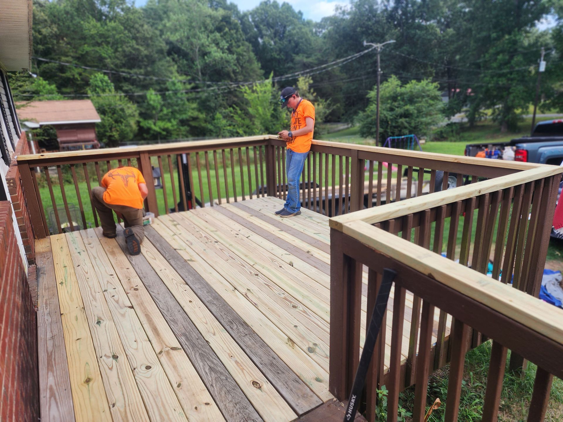 A men working on a wooden deck.