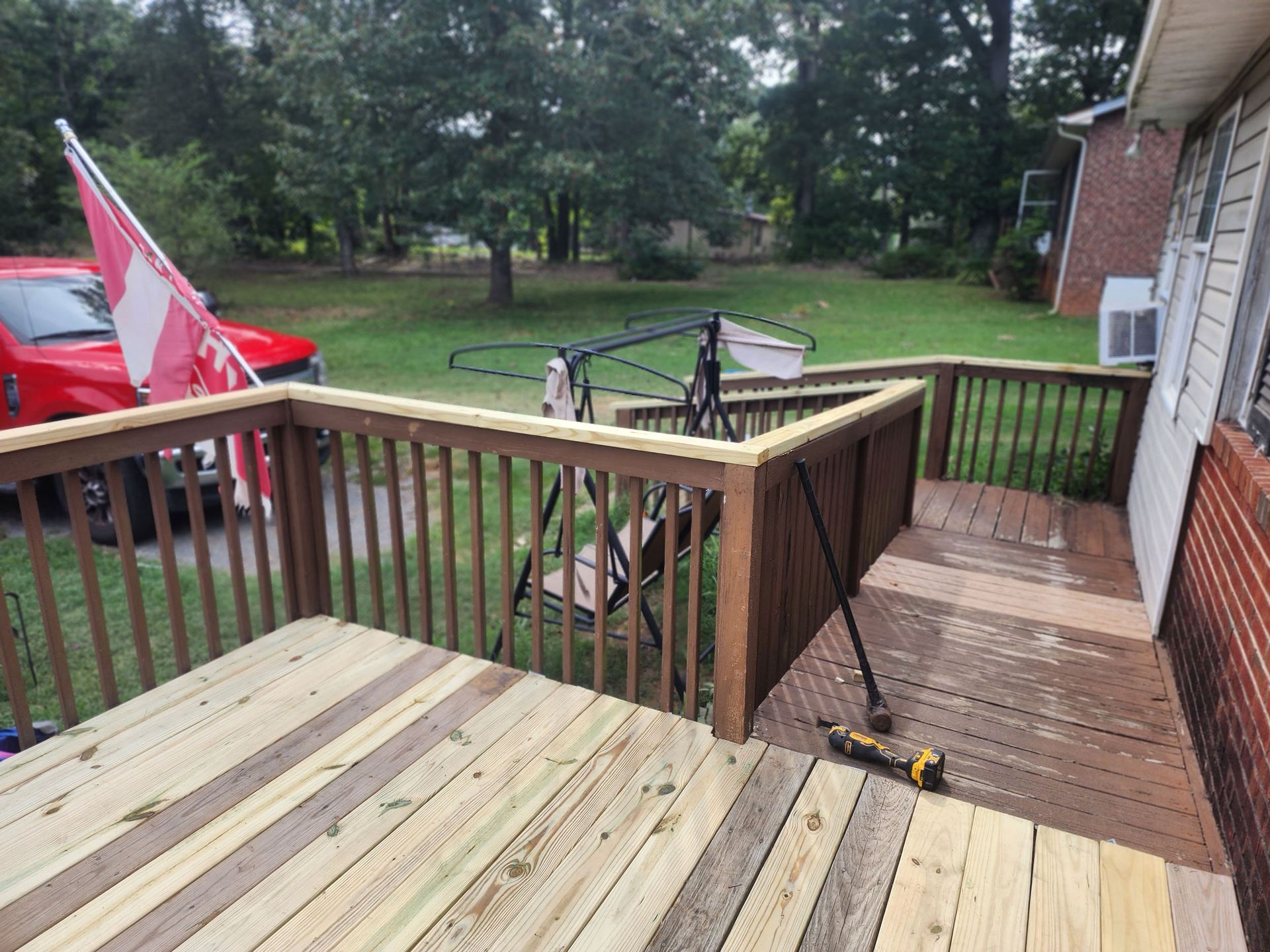 A wooden deck is being built in front of a house.