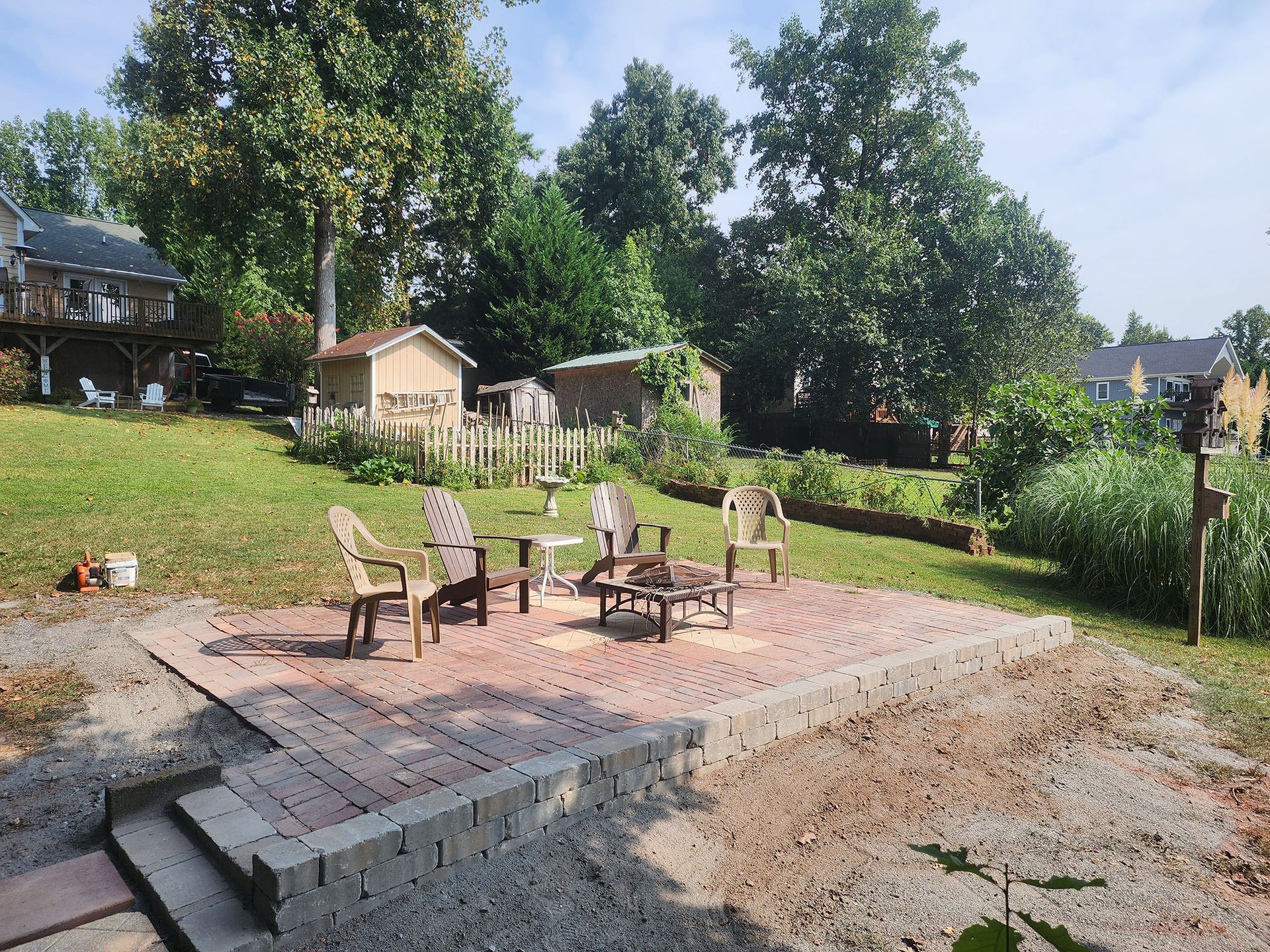 There is a fire pit in the middle of the backyard.
