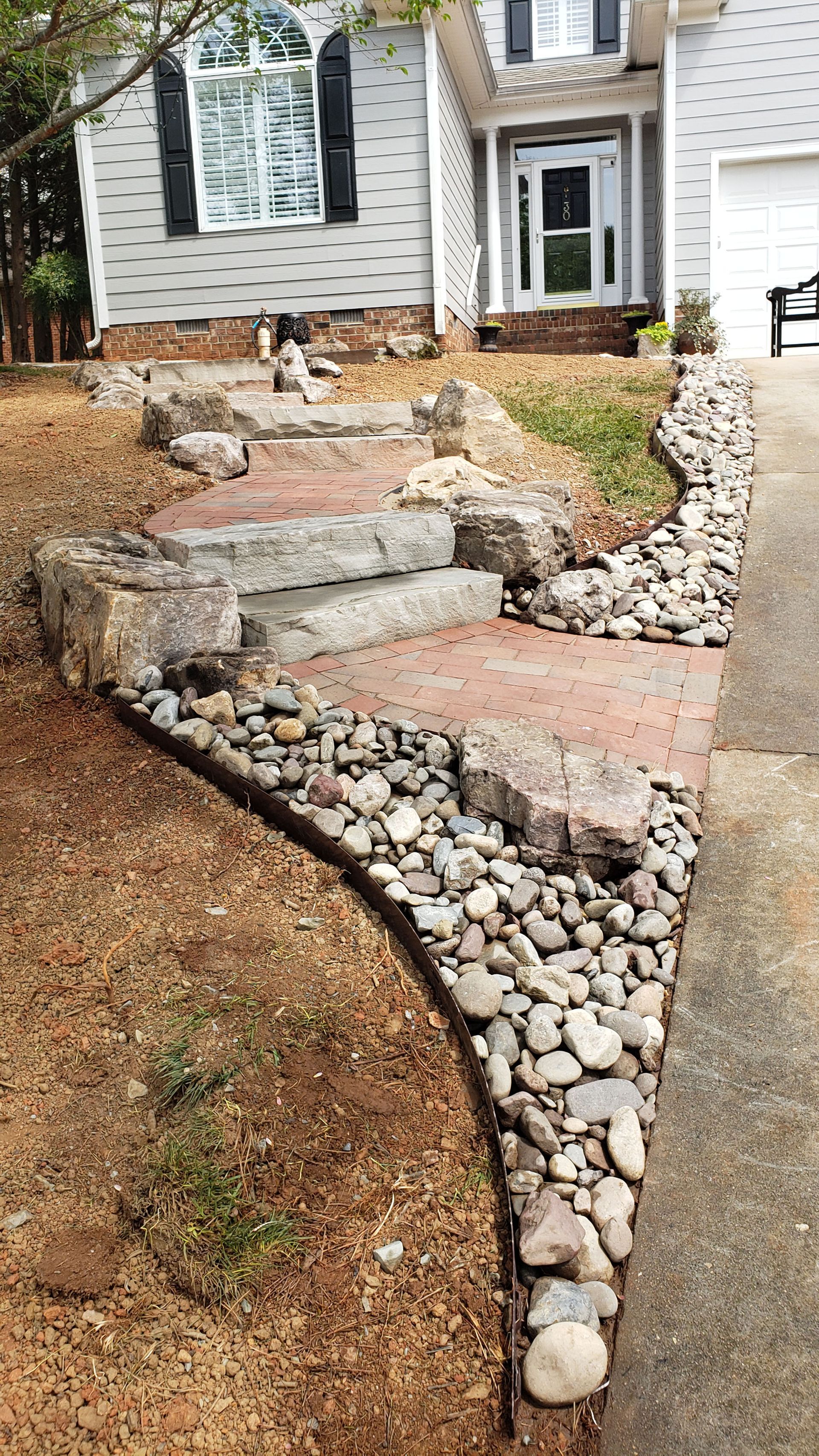 A stone walkway leading to the front door of a house.