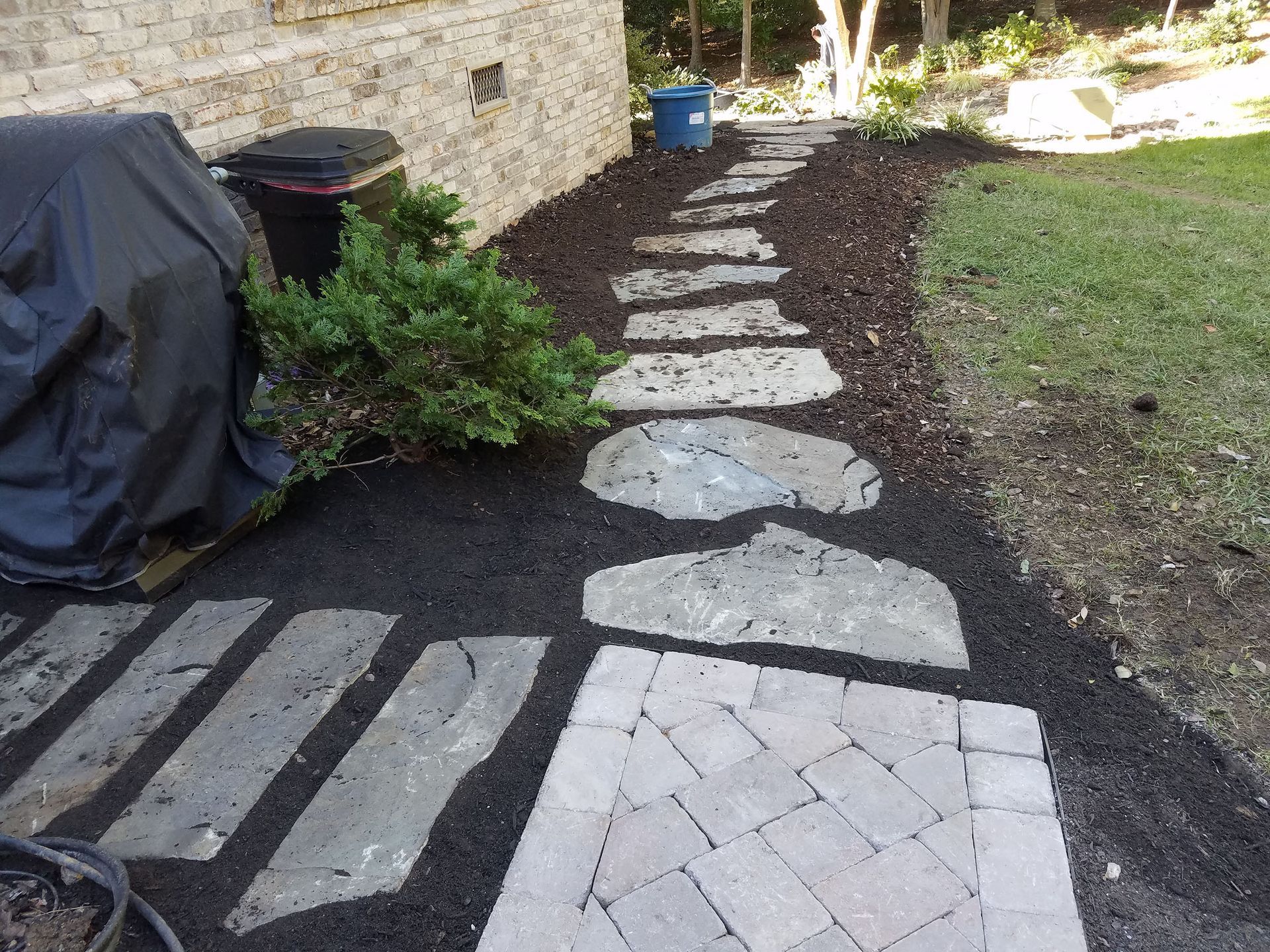A stone walkway leading to a brick building