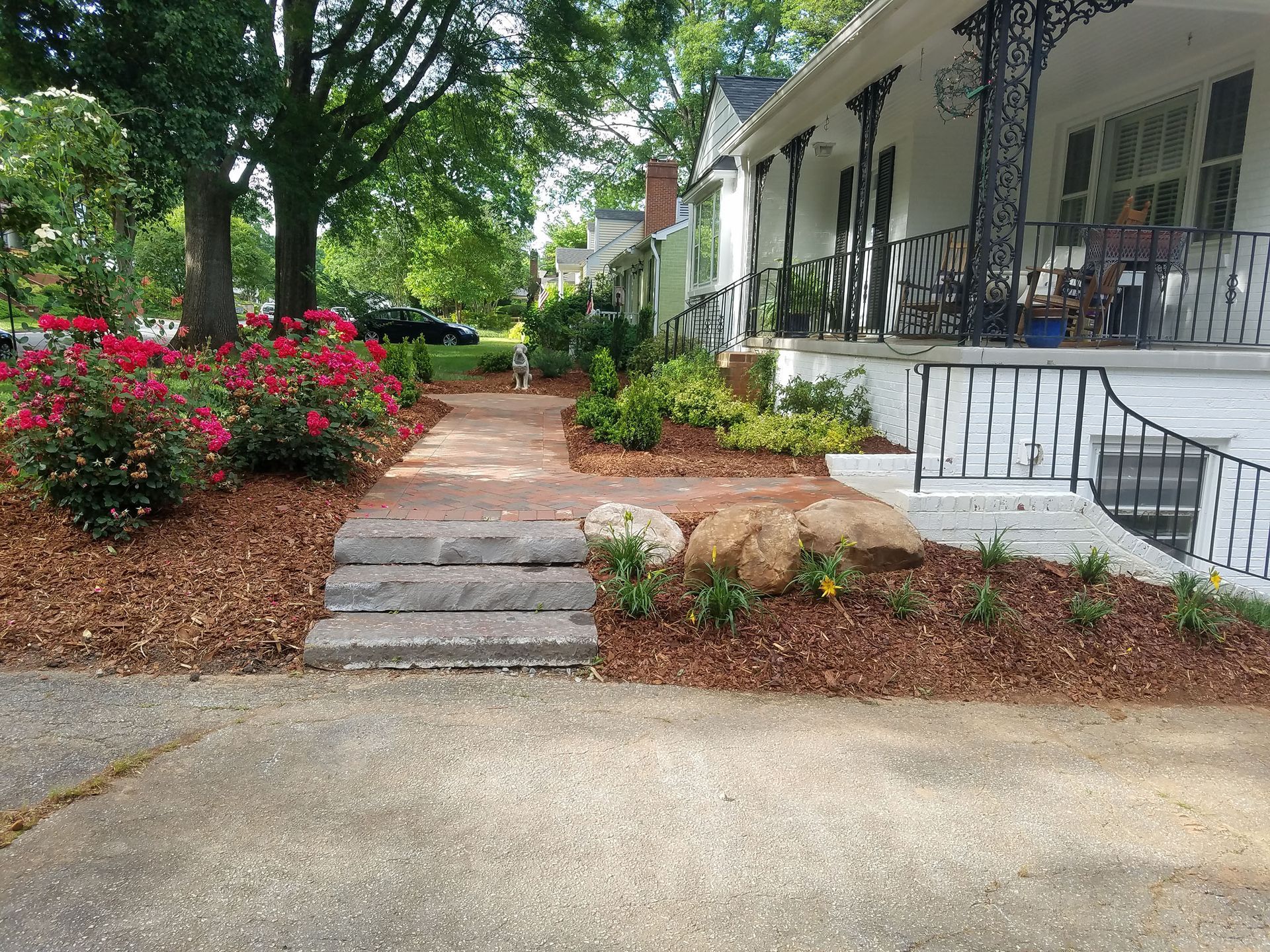 A house with a porch and a walkway leading to it