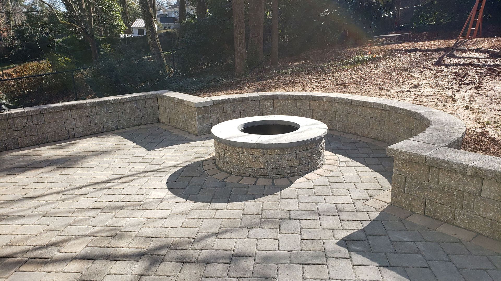 There is a fire pit in the middle of the patio.