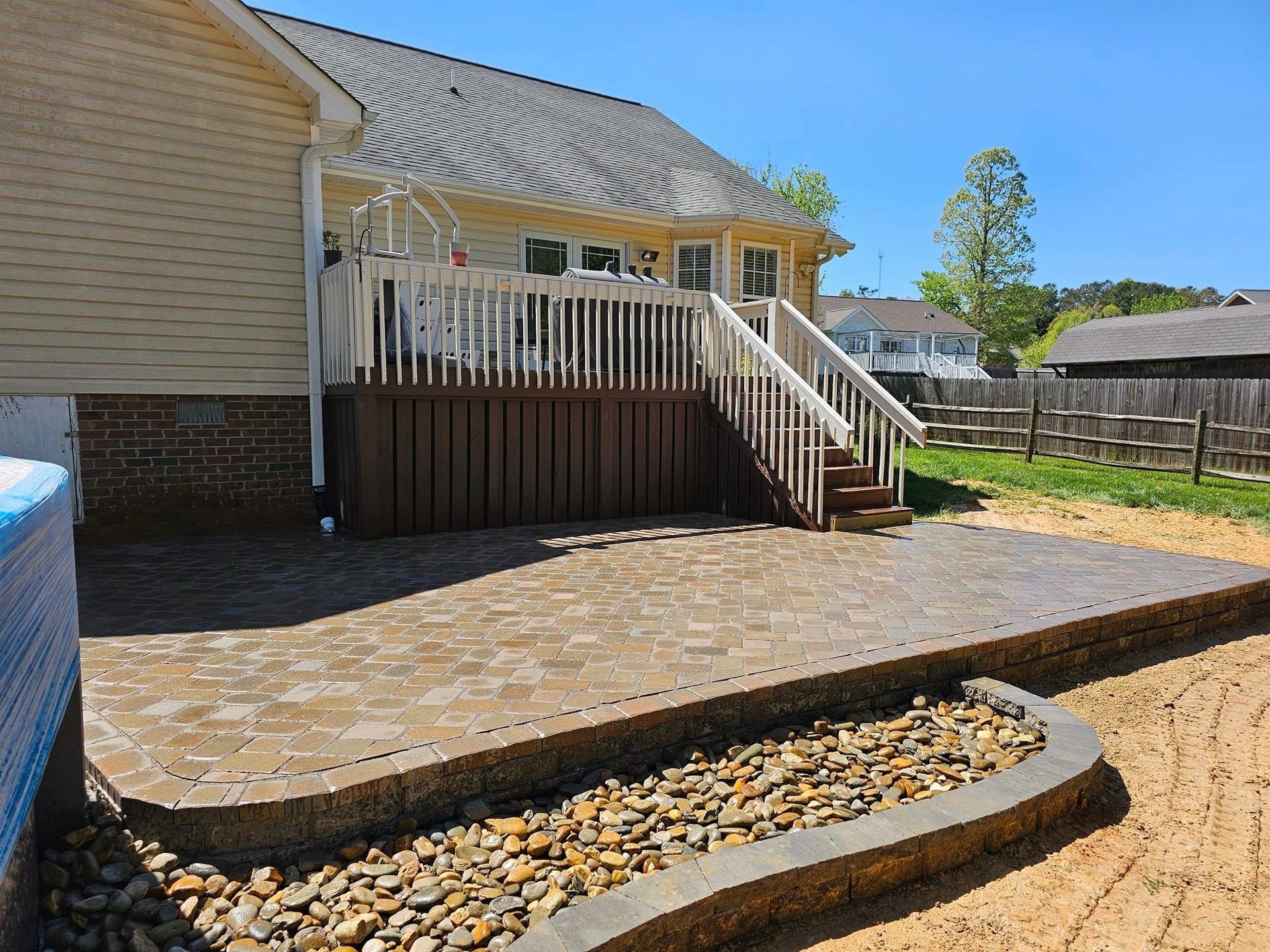 A house with a patio and stairs leading up to it.