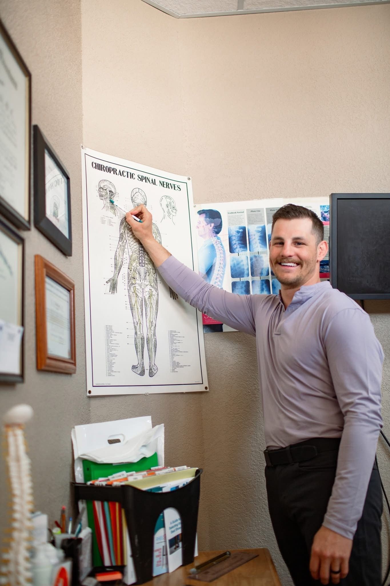 Man pointing at an anatomical chart