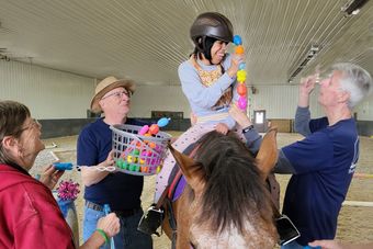 A little girl next to a horse