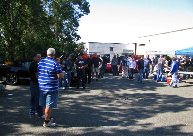 A group of people are gathered in a parking lot
