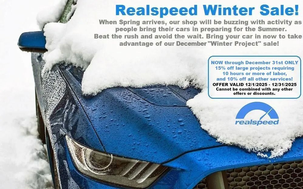 Blue car covered in snow, advertisement for Realspeed Winter Sale, offering discounts.