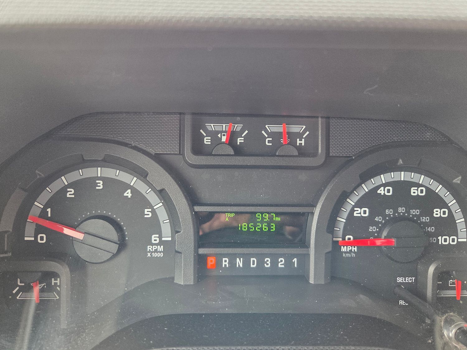 Car dashboard with speedometer, fuel and temperature gauges, and gear indicator showing Park.