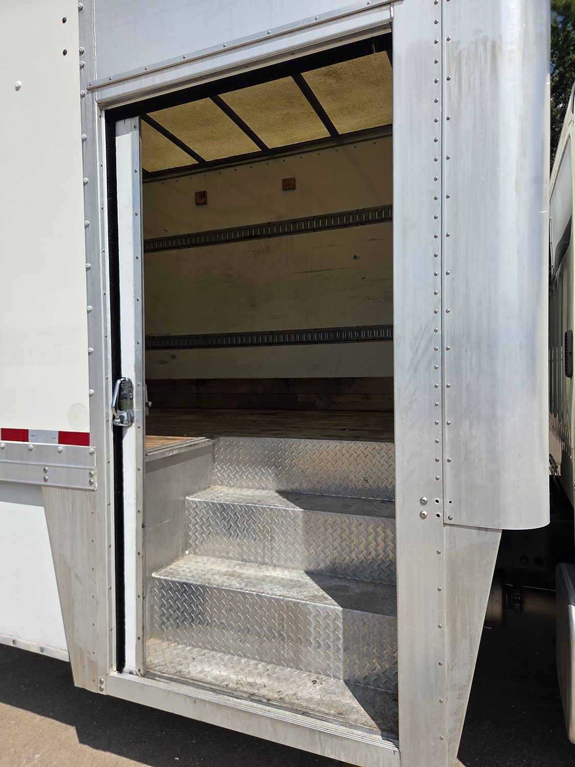 Truck cargo bay with metal steps at the open rear door