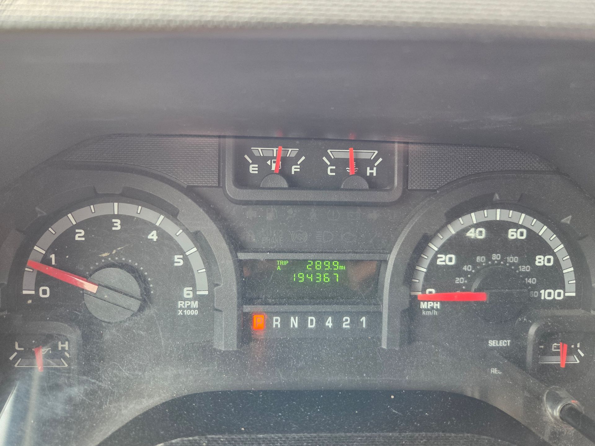 Car dashboard with speedometer, tachometer, fuel and temperature gauges, and a digital gear display.