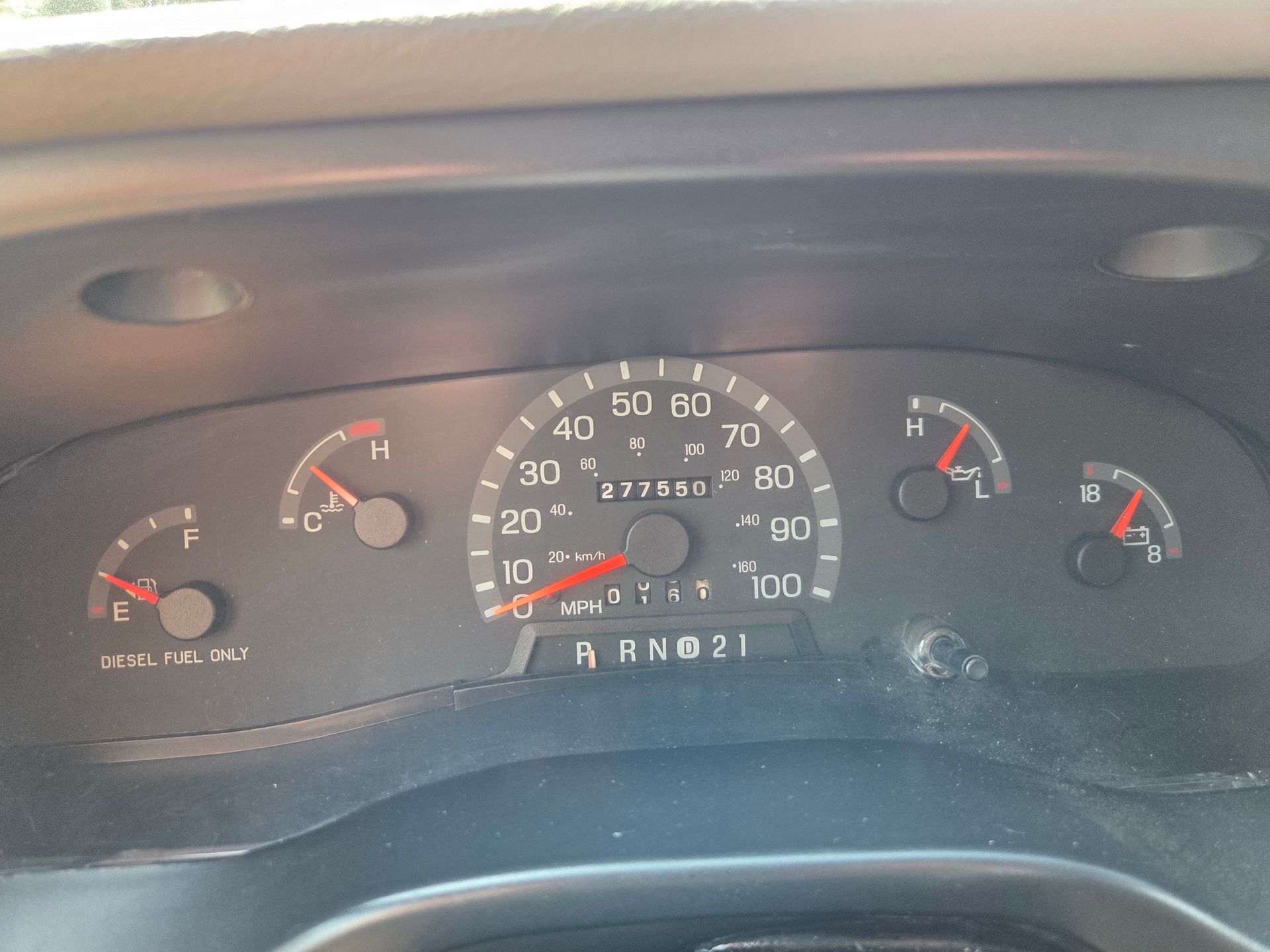 Car dashboard instrument cluster with speedometer and gauges, key off.