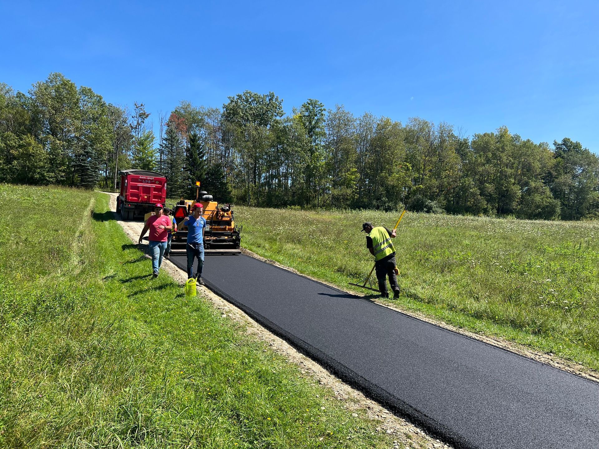 A group of people are walking down a road.