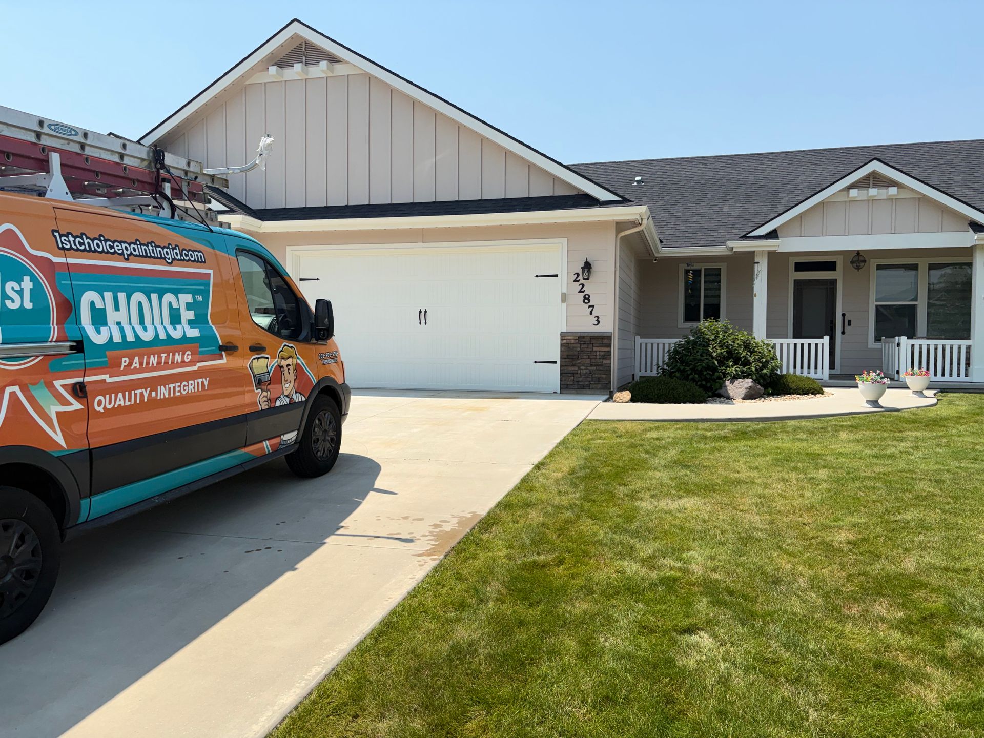 Orange service van parked beside a suburban house with a white garage and green lawn