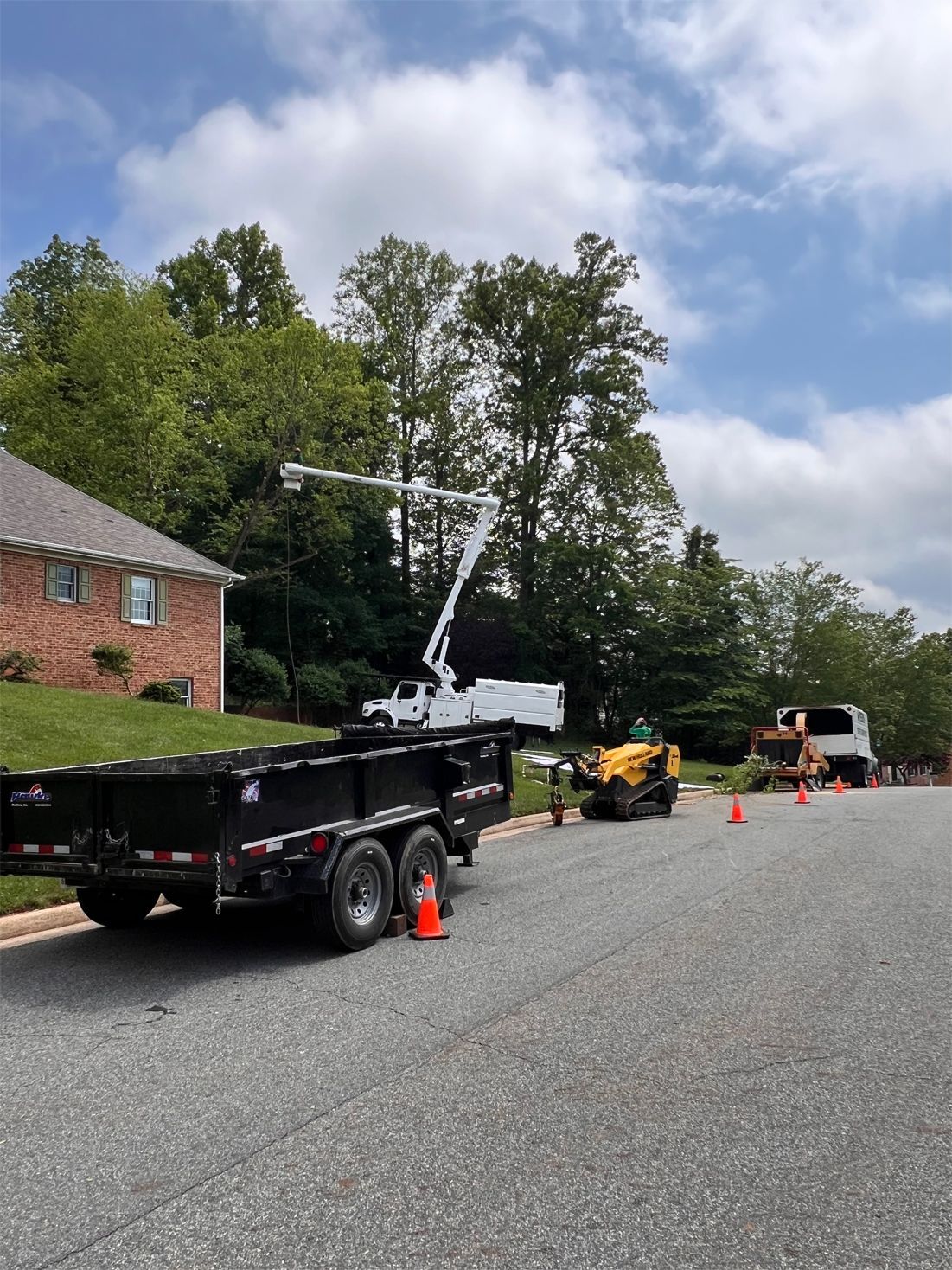 A truck is parked on the side of the road next to a house.