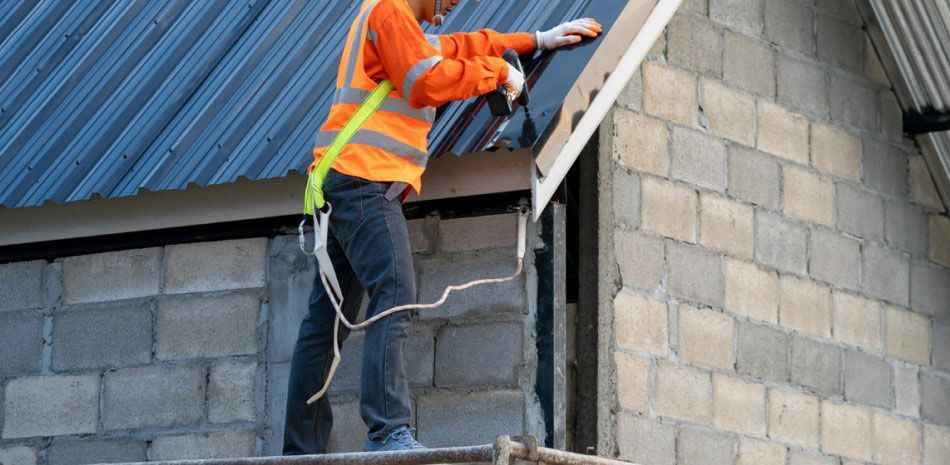 A man is working on the roof of a building.