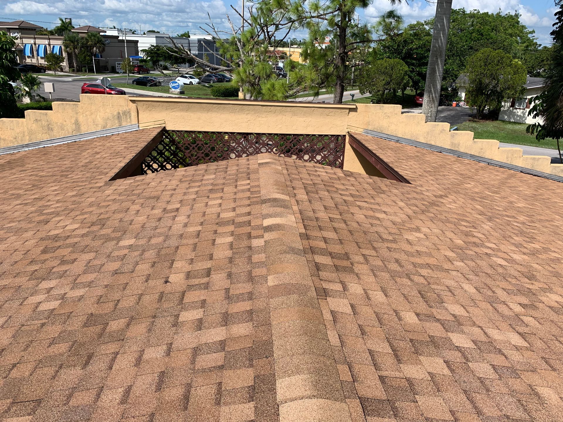 Brick-paved rooftop with a central skylight opening under a sunny sky