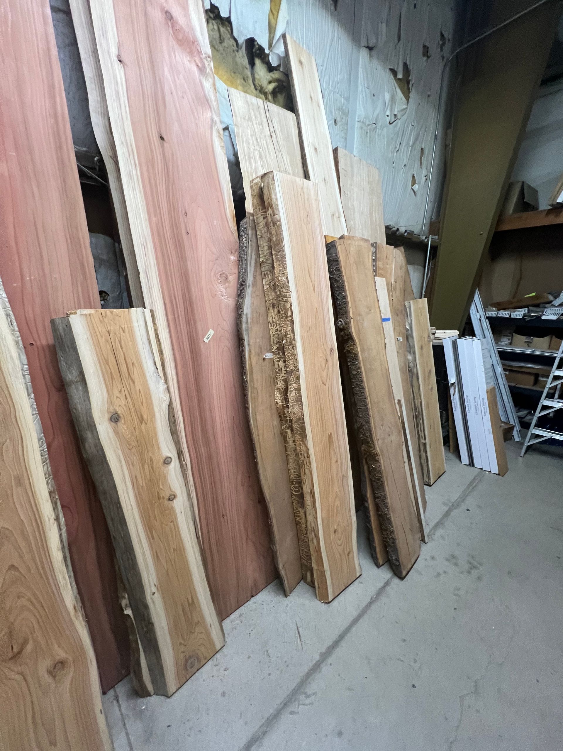 A bunch of wood pieces are stacked on top of each other in a room.