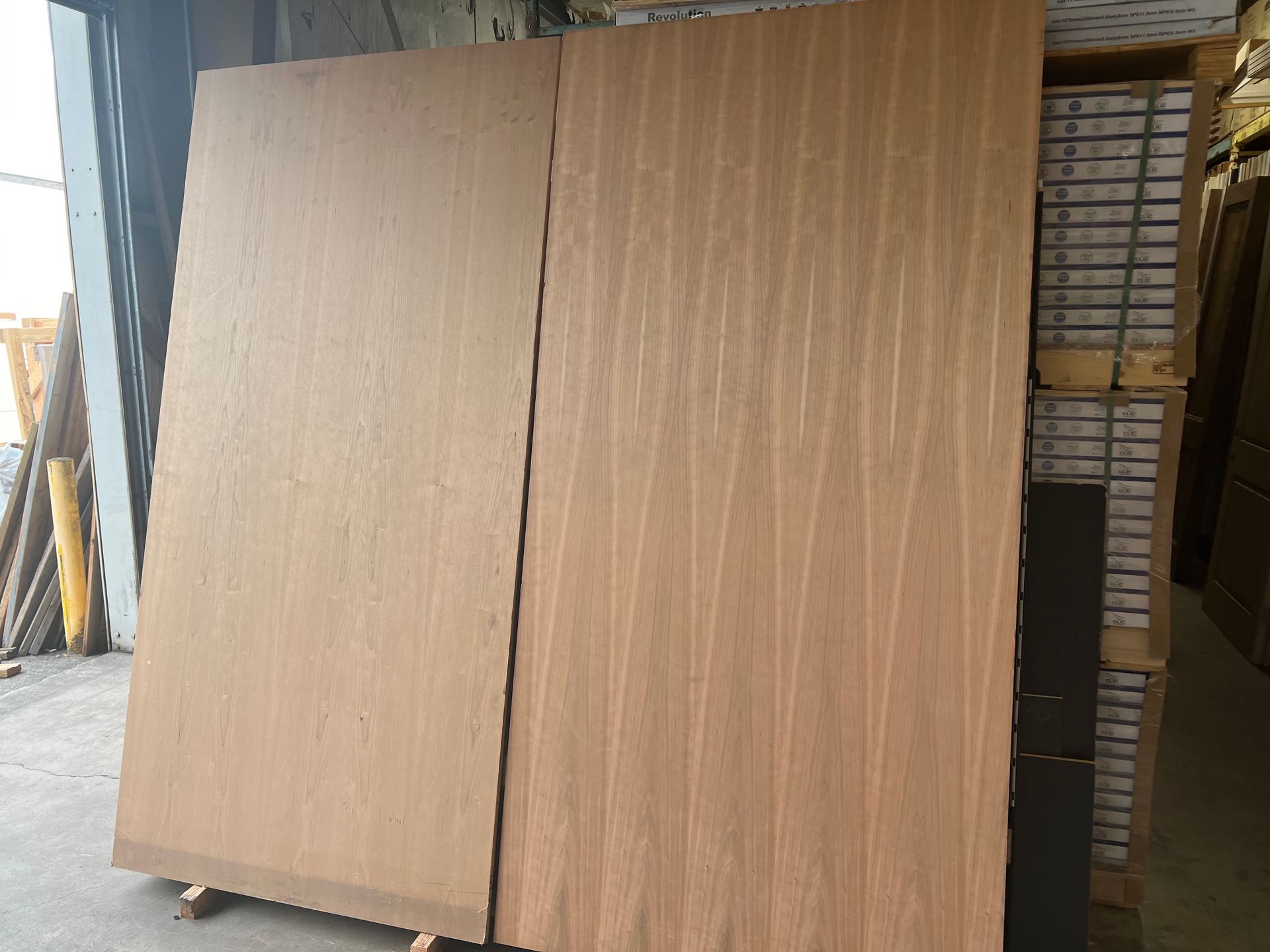 Two pieces of wood are stacked on top of each other in a warehouse.