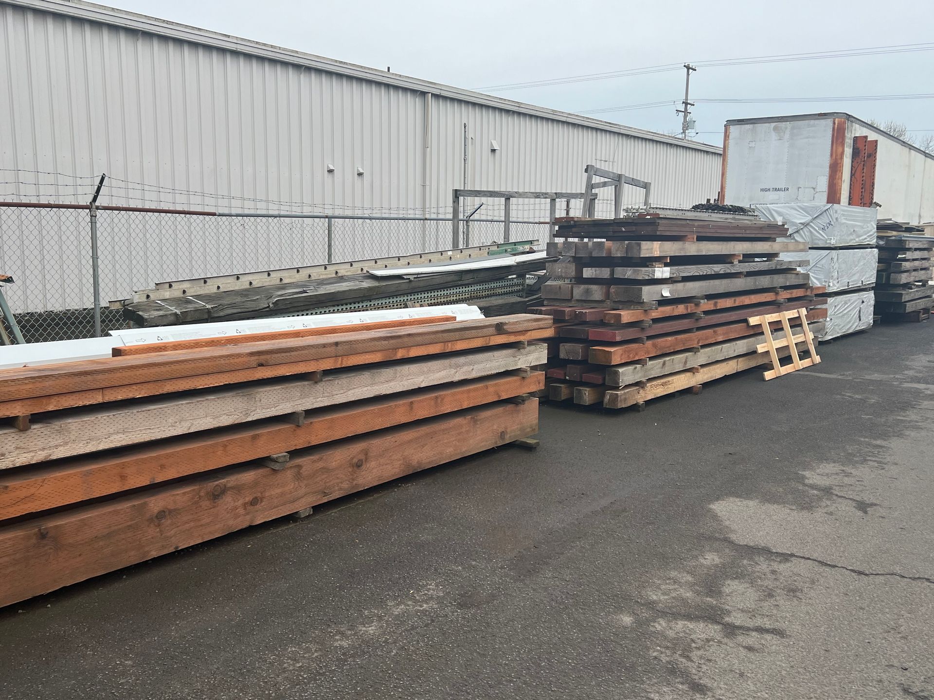 A bunch of wooden beams are stacked on top of each other.