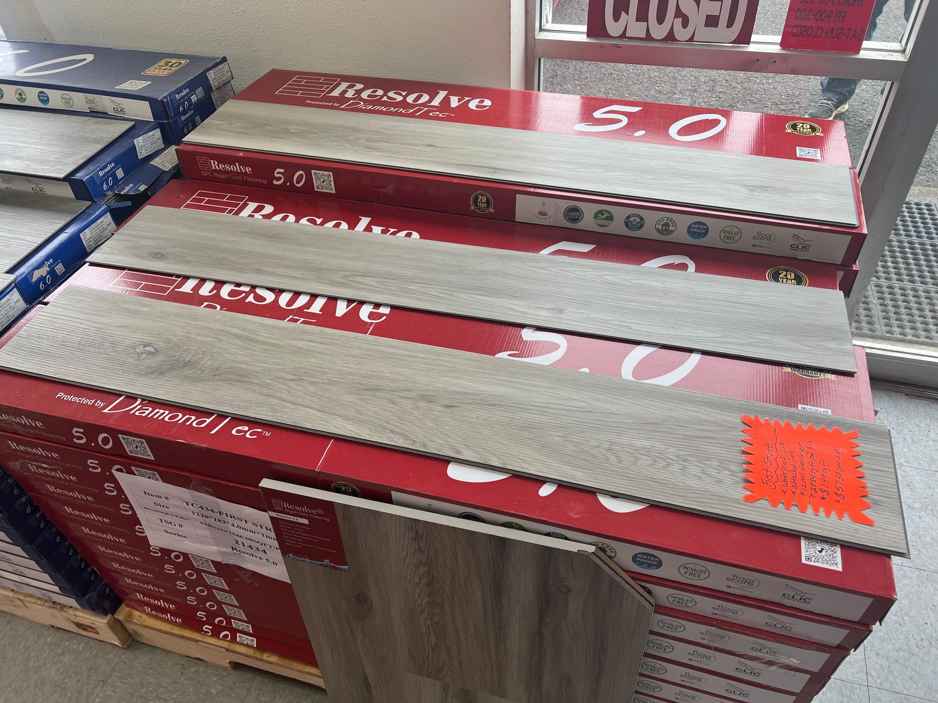 A bunch of boxes of tiles are stacked on top of each other in a store.