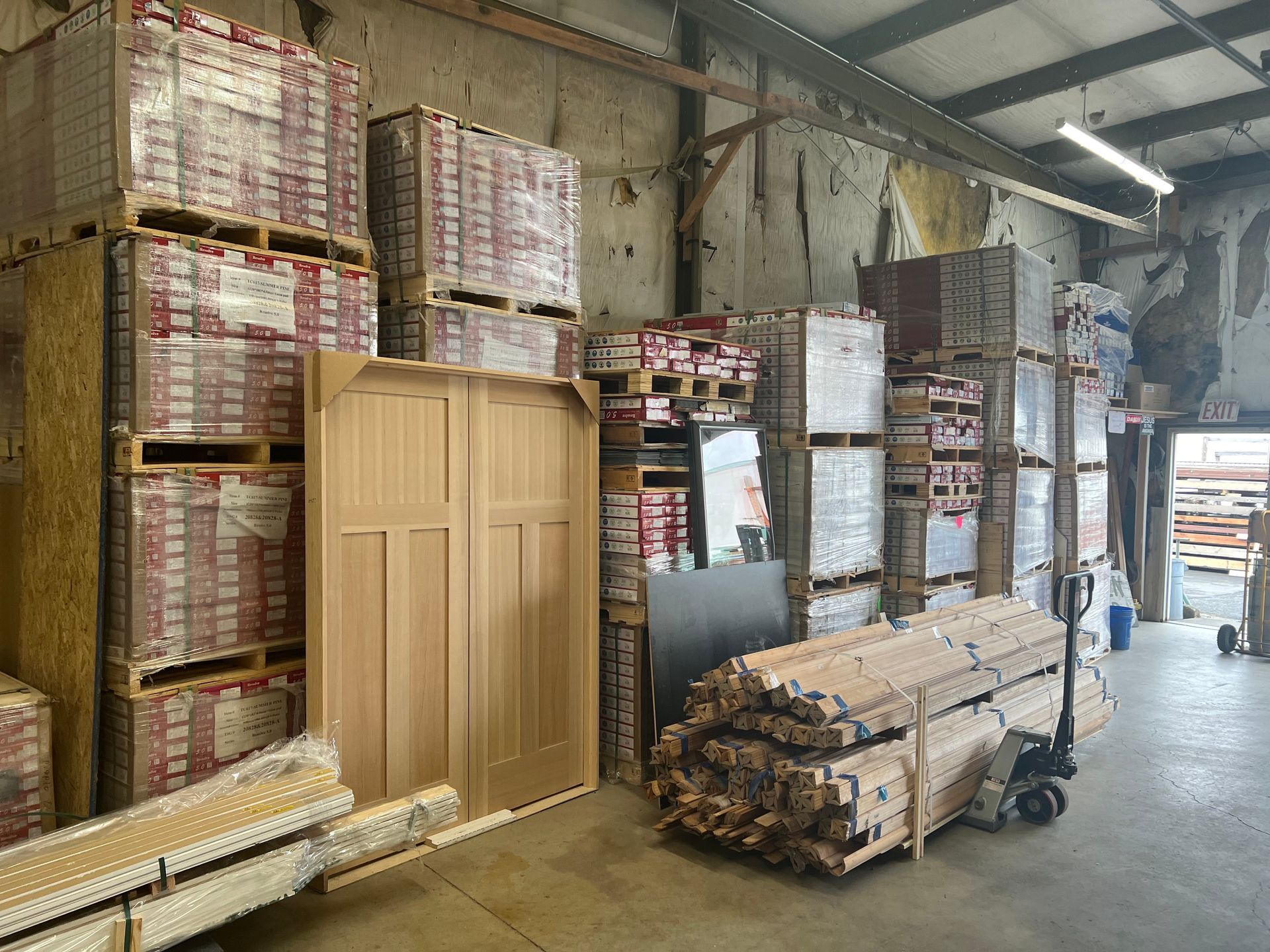 A warehouse filled with lots of wooden pallets and boxes.