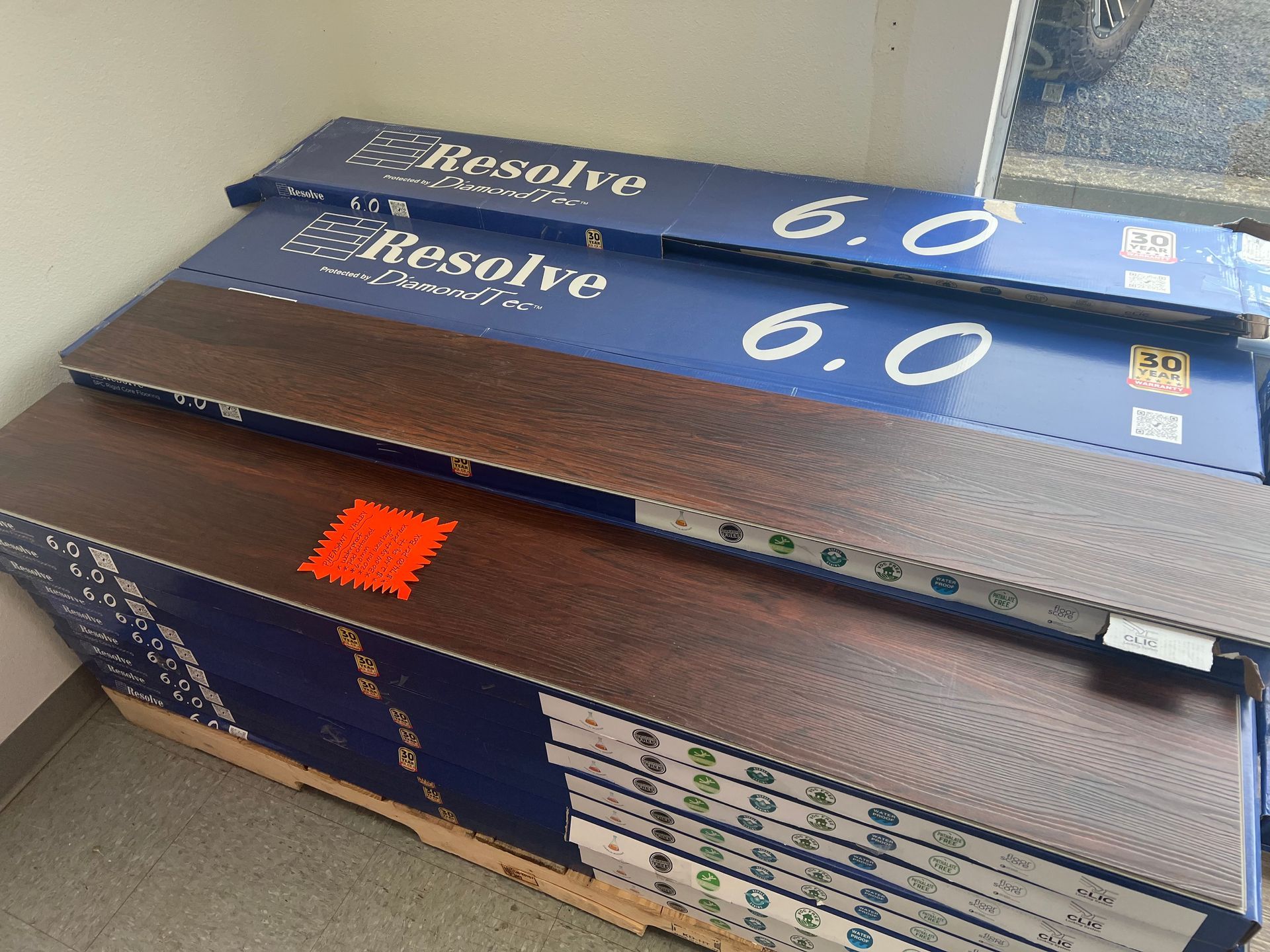 A stack of wooden flooring sitting on top of a wooden pallet.