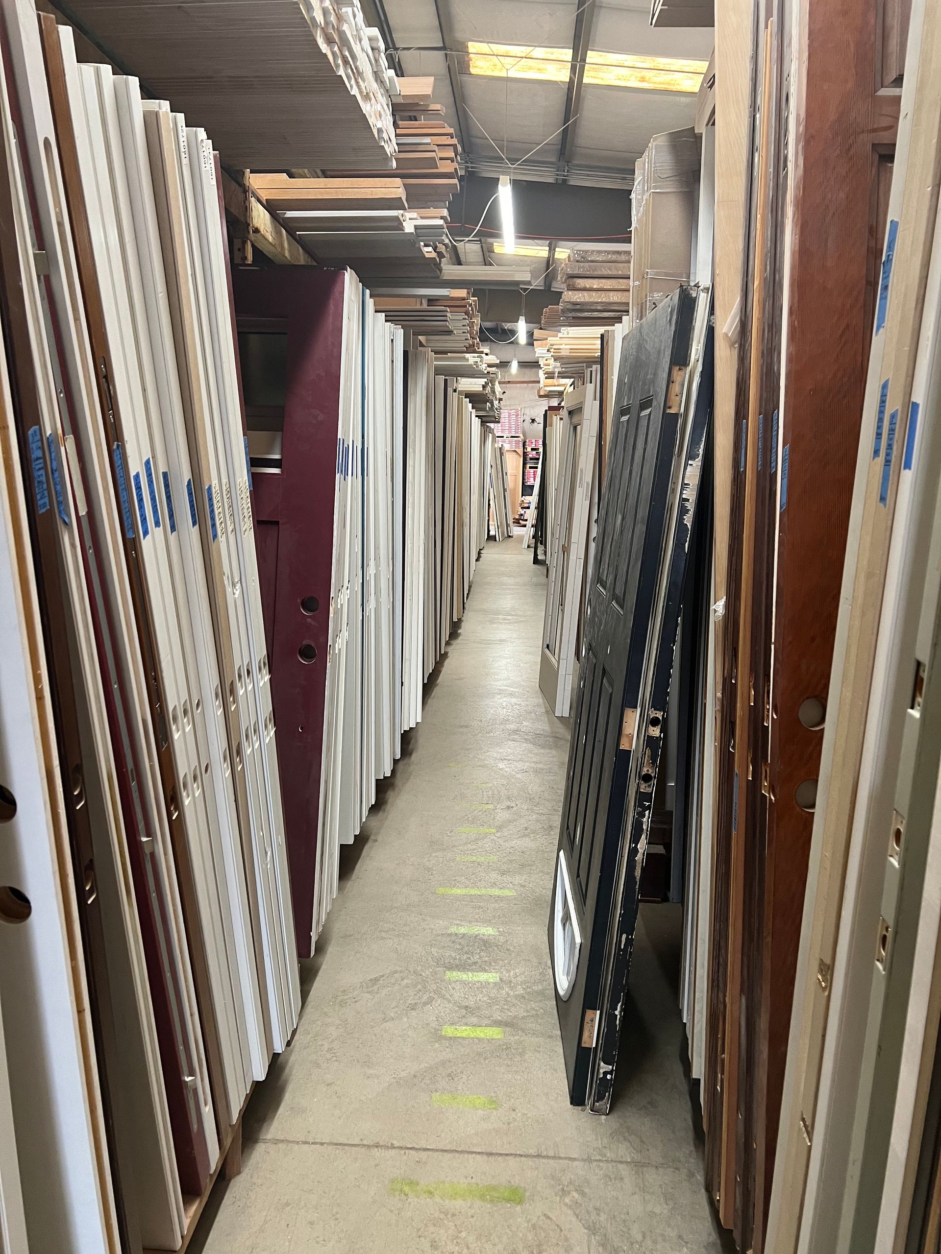 A long hallway filled with lots of pieces of wood.