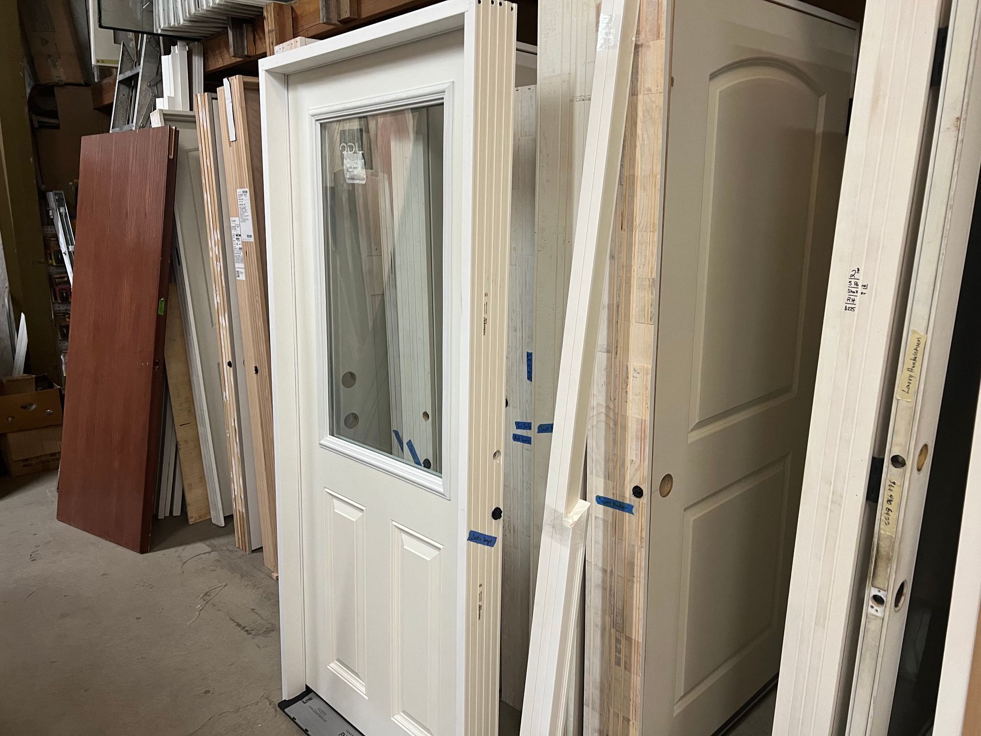 A bunch of doors are stacked on top of each other.