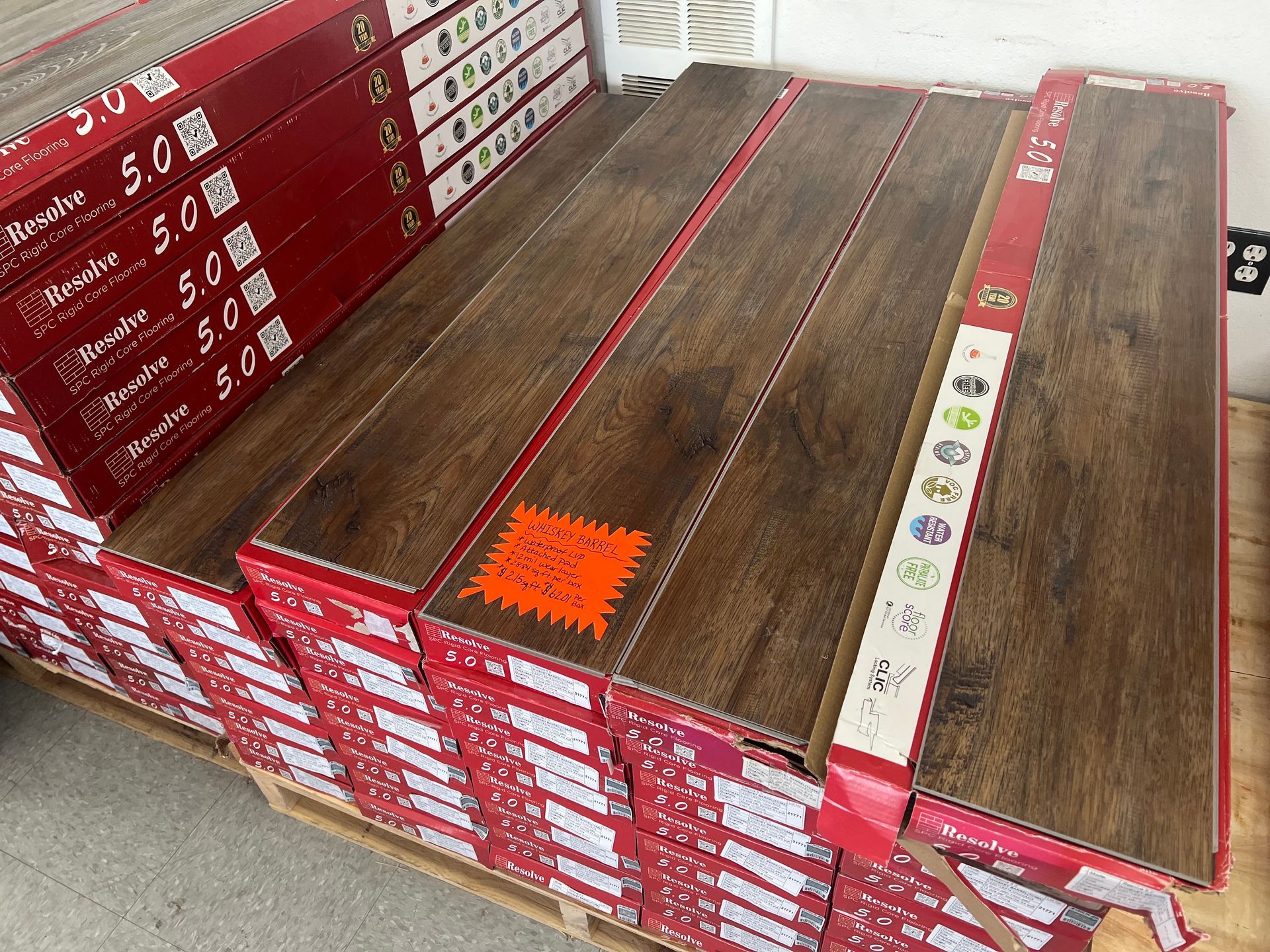 A stack of wooden flooring sitting on top of a wooden pallet.