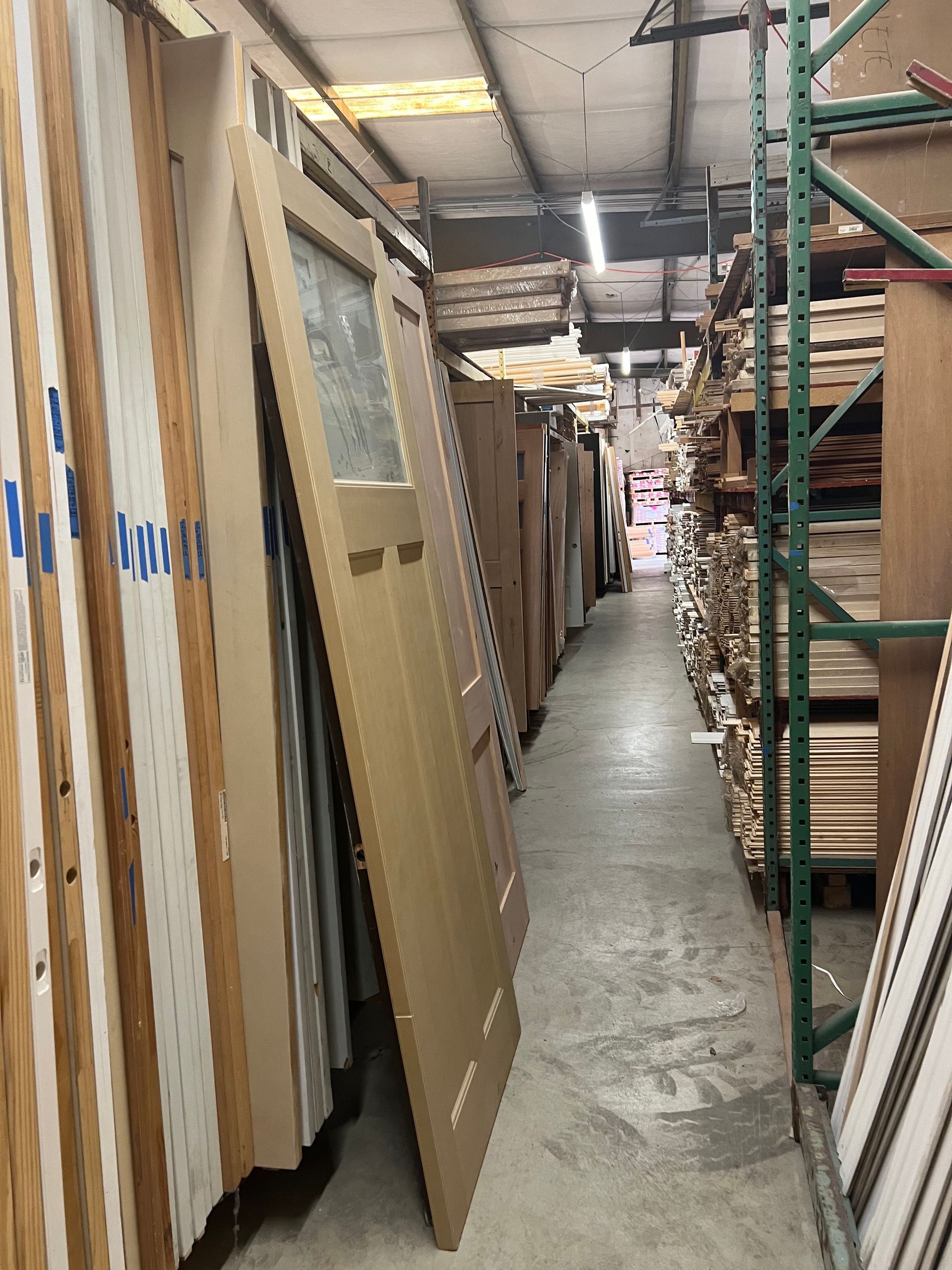 A warehouse filled with lots of cardboard boxes and shelves.