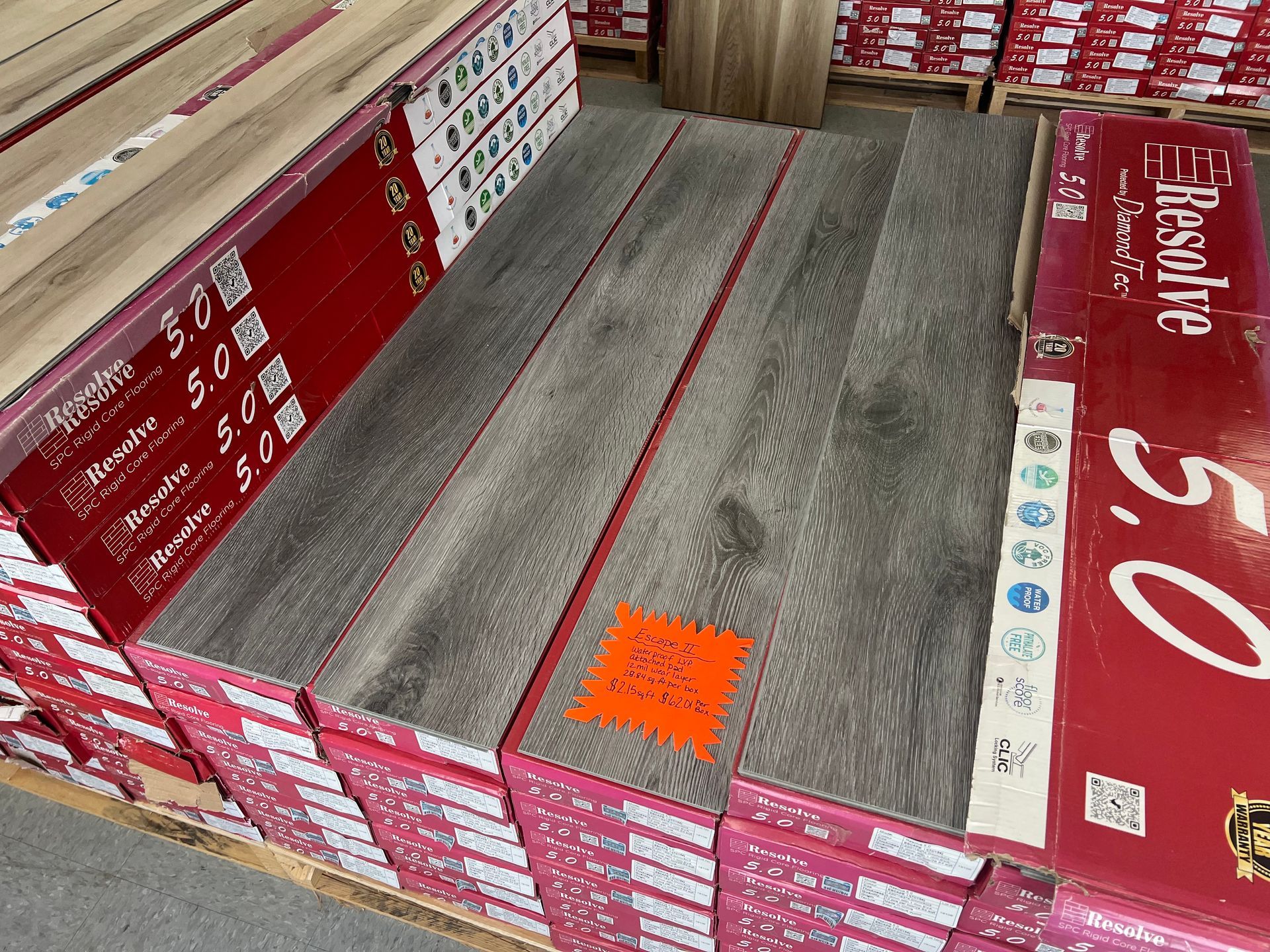 A bunch of boxes of flooring are stacked on top of each other.