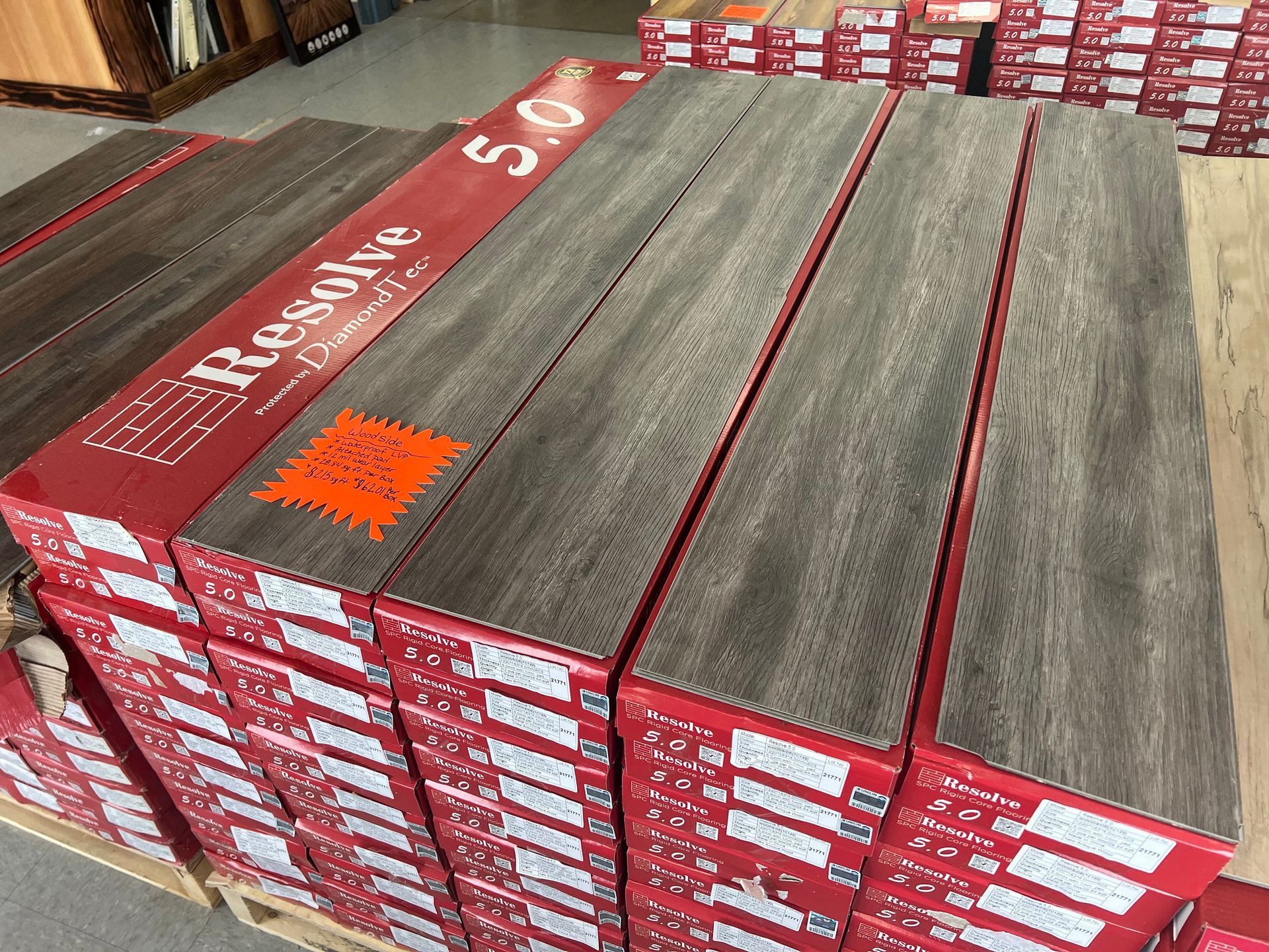 A pallet of hardwood flooring is stacked on top of each other.