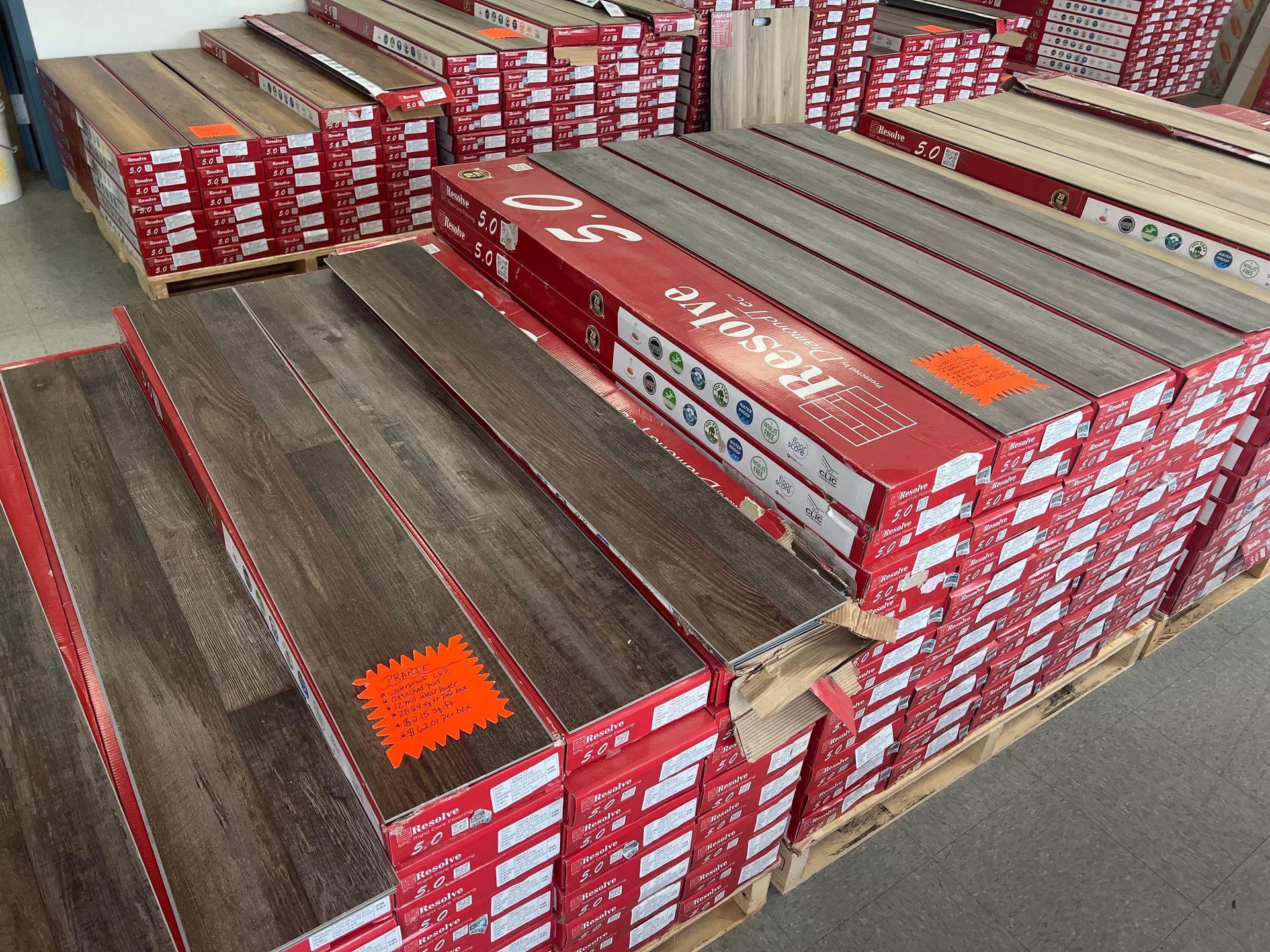 A warehouse filled with lots of boxes of hardwood flooring.