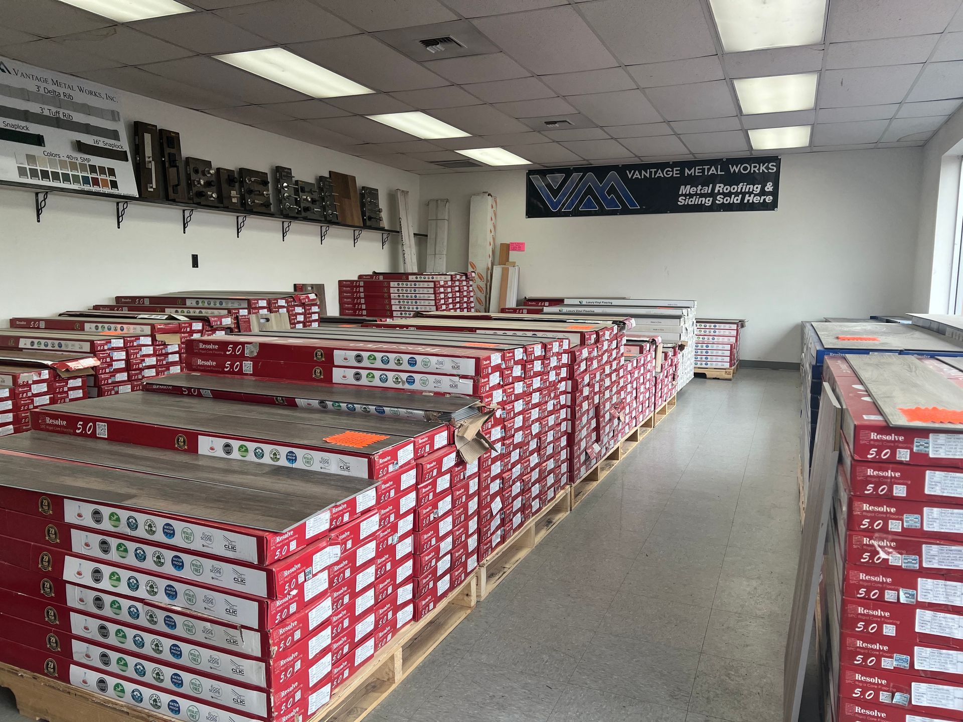 A large room filled with lots of boxes of flooring.