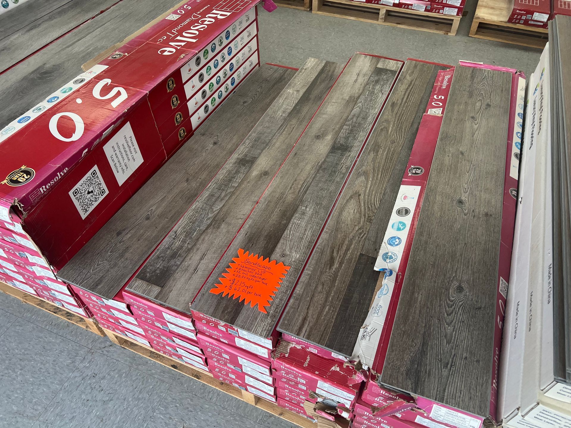 A pallet of wooden flooring is sitting on top of a pallet.