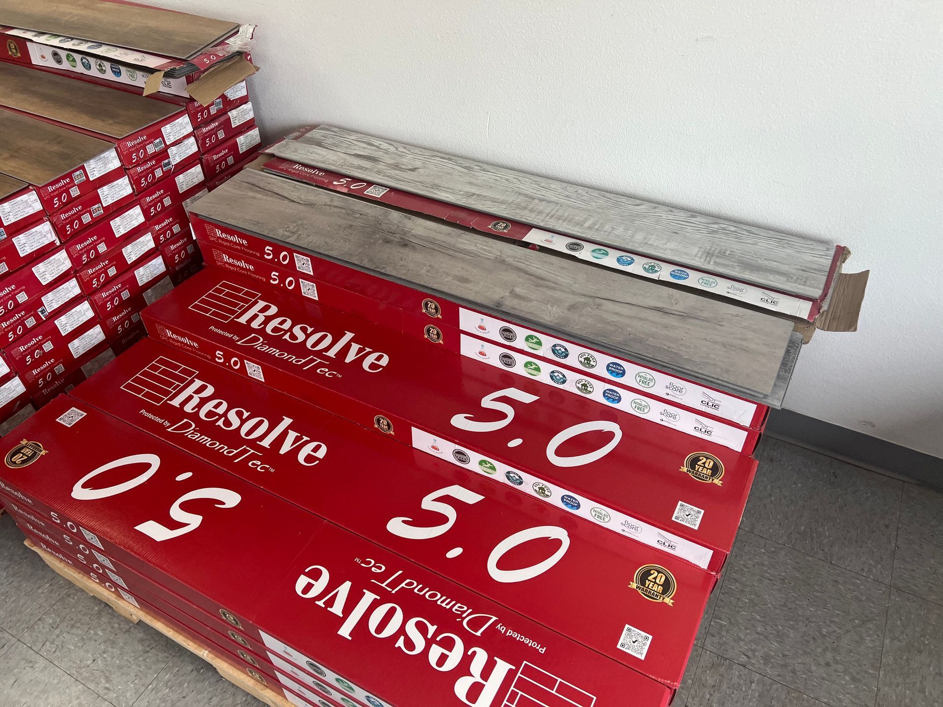 Boxes of resolve 5.0 flooring are stacked on top of each other.