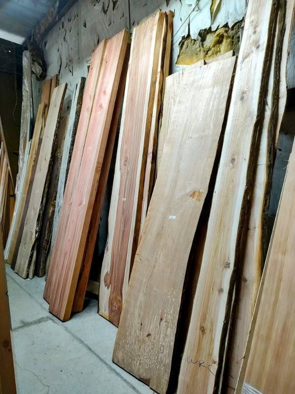 A bunch of wooden boards are stacked on top of each other in a room.