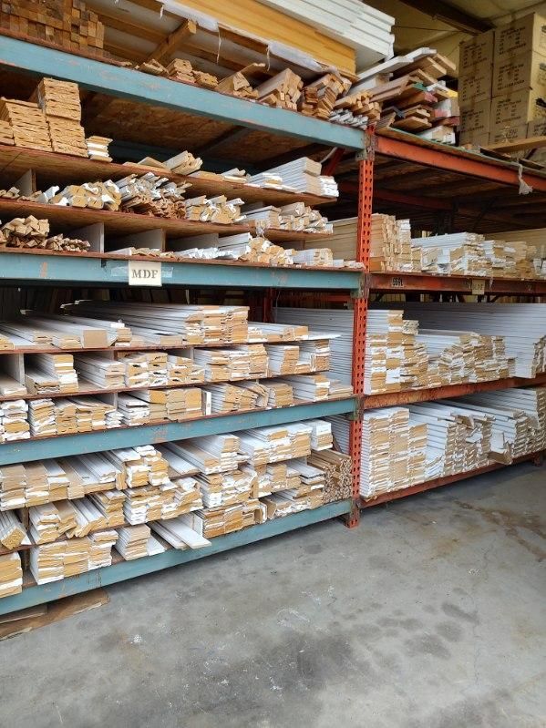 A warehouse filled with shelves filled with lots of wood.
