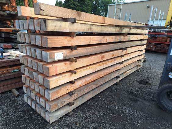 A pile of wooden beams stacked on top of each other.