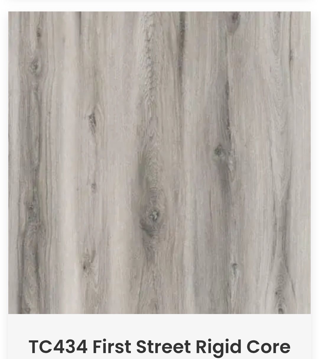 A sample of TC434 First Street rigid core flooring with a light gray, weathered wood grain pattern