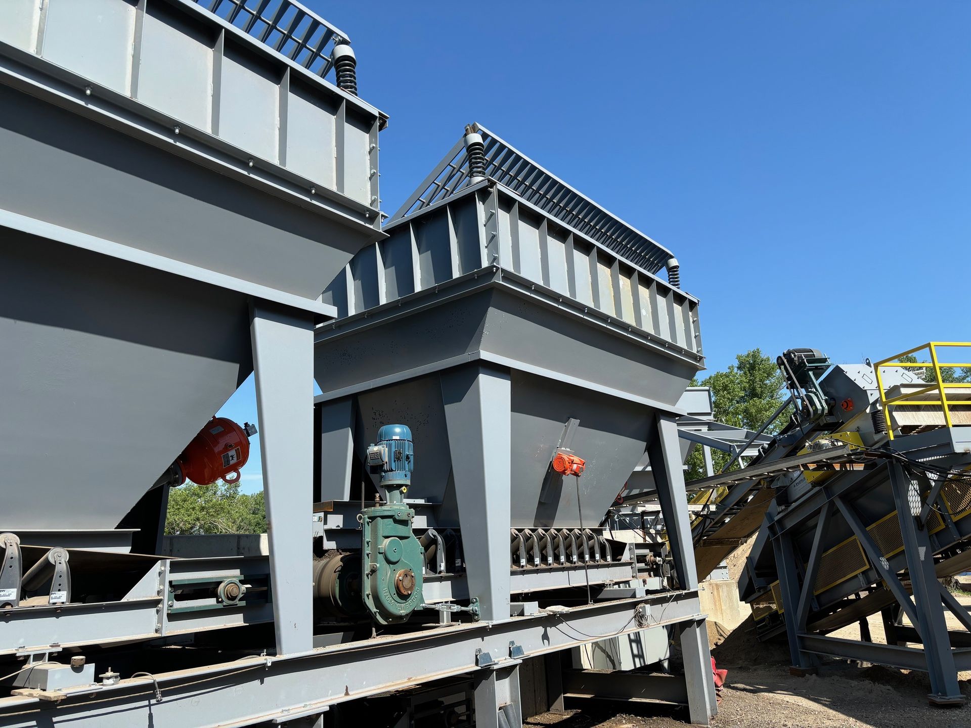 A couple of gray containers are sitting on top of a trailer.