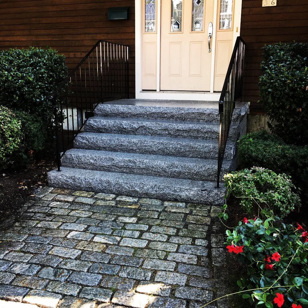 A stone walkway leading to the front door of a house