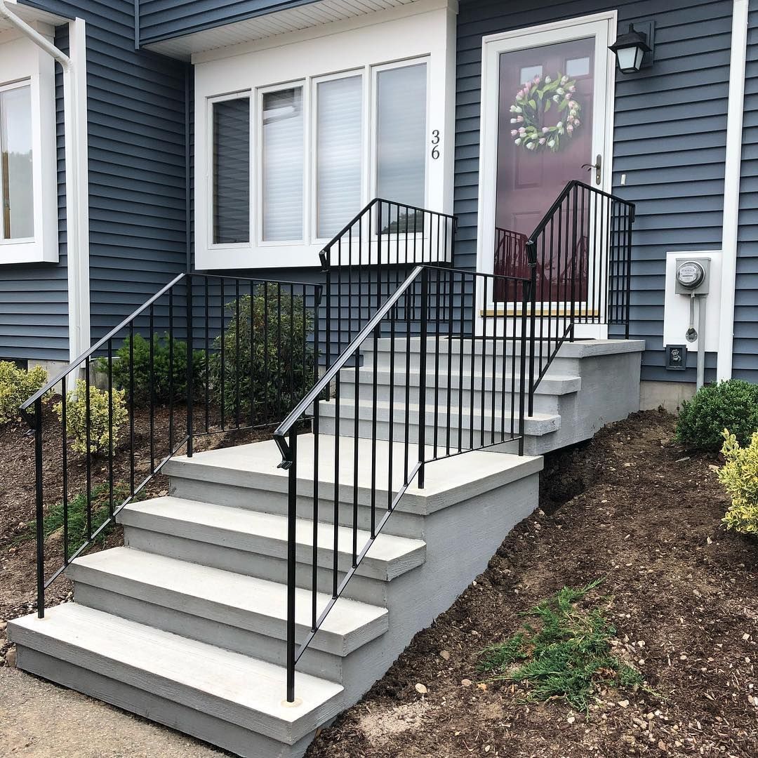 A blue house with stairs and a wreath on the door