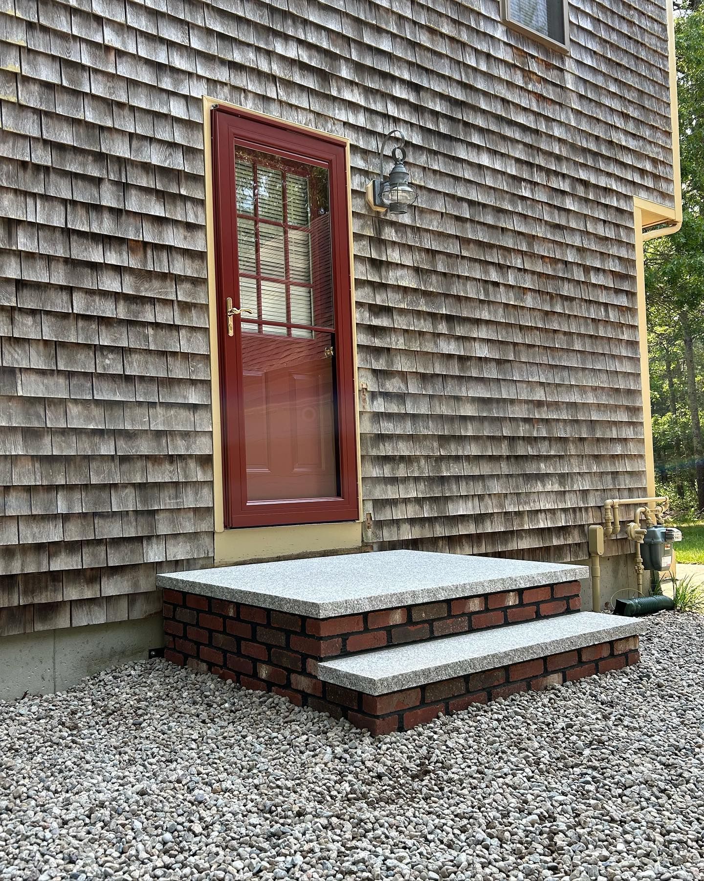 A house with a red door and steps in front of it