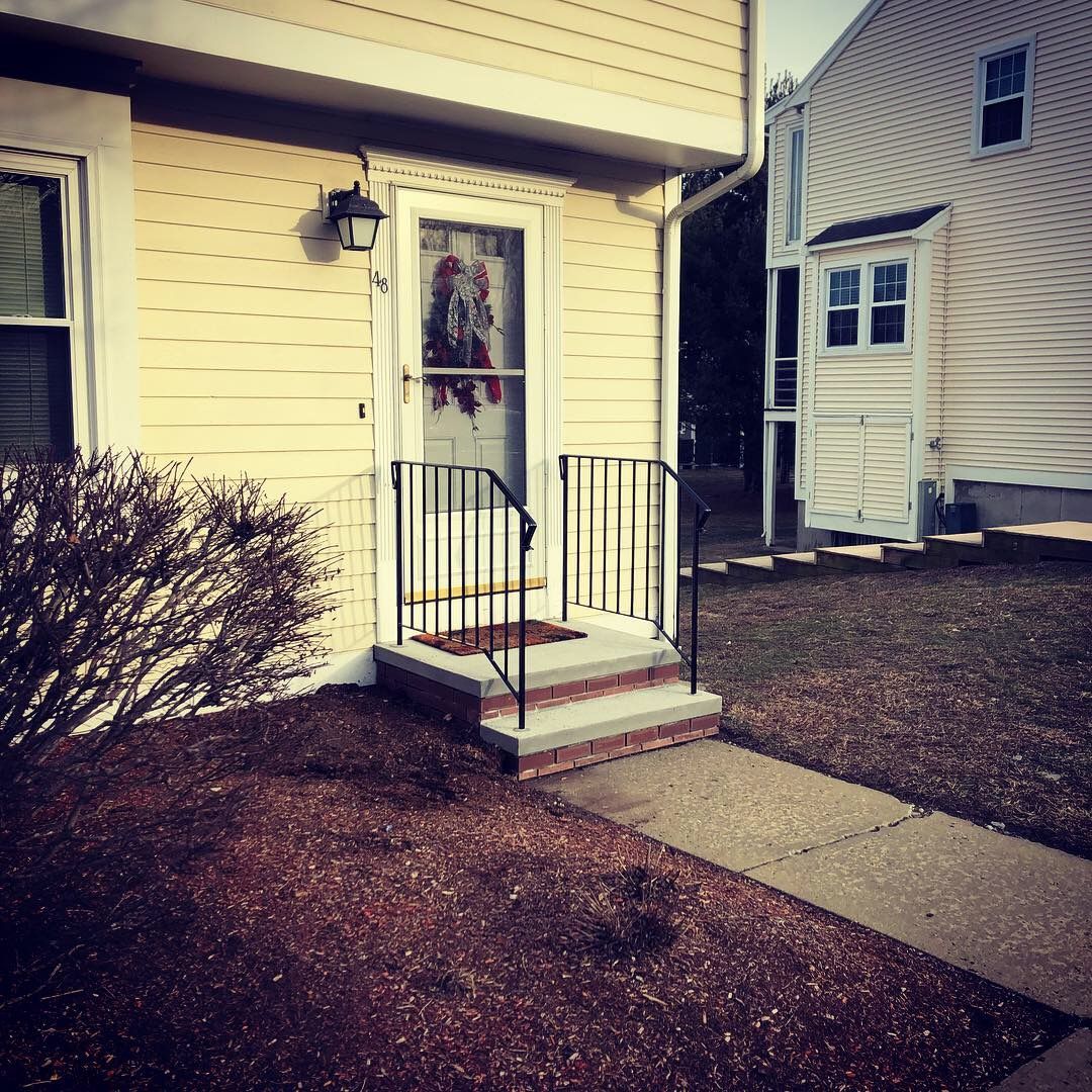 The front door of a house with a wreath on it