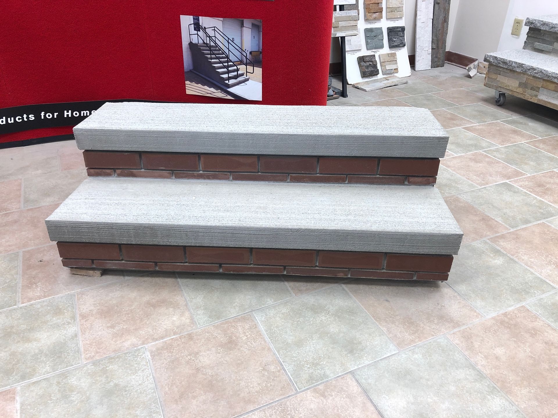 A set of stairs with a picture of a staircase on the wall behind them